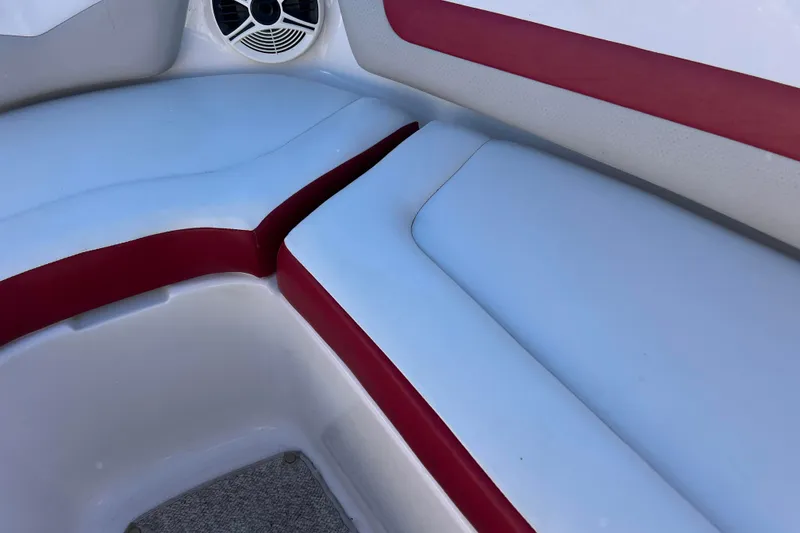 Slide: The Image of 2010 Chaparral 216 SSi boat interior with red and white seating and speaker. - 45