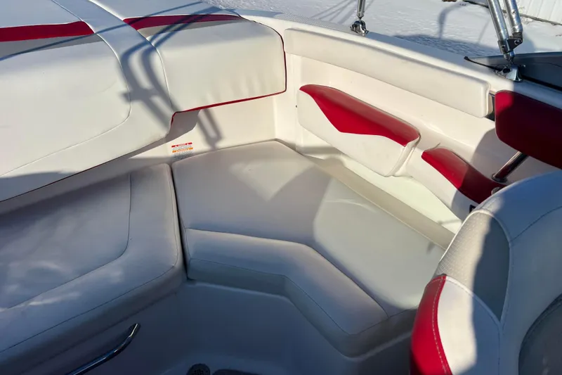 Slide: The Image of Interior seating of 2010 Chaparral 216 SSi boat with white and red upholstery. - 51