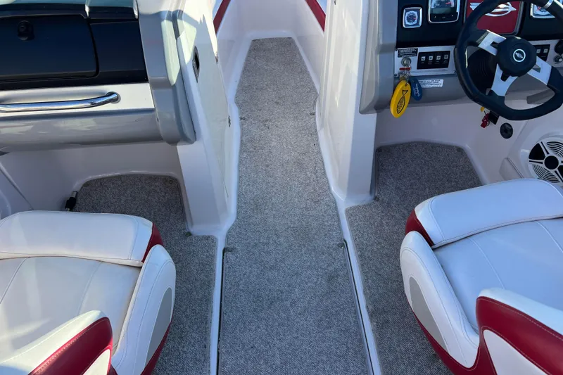 Slide: The Image of Interior of a 2010 Chaparral 216 SSi boat with red and white seating. - 53