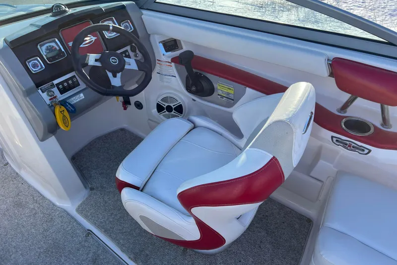 Slide: The Image of Interior of 2010 Chaparral 216 SSi boat with steering wheel and red-white seating. - 54