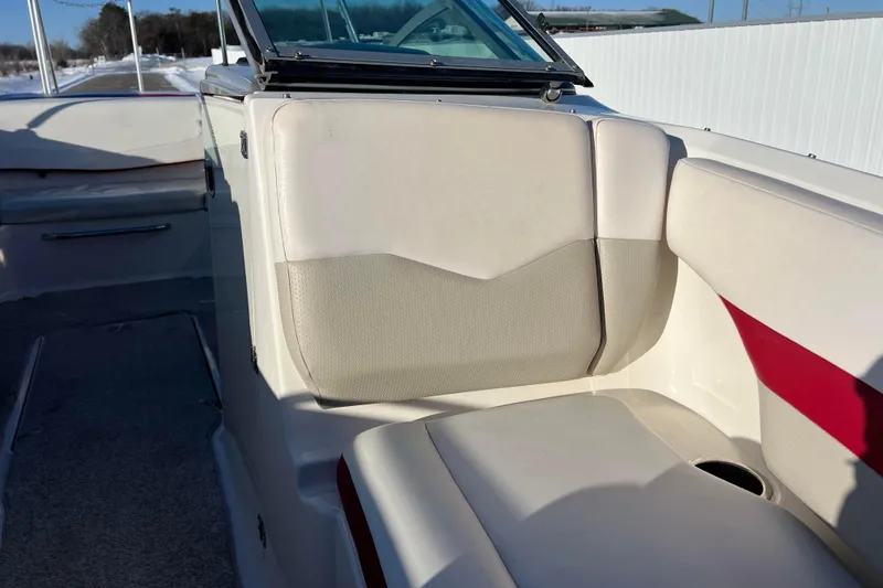 Slide: The Image of 2010 Chaparral 216 SSi boat interior with beige seating and red accents. - 57