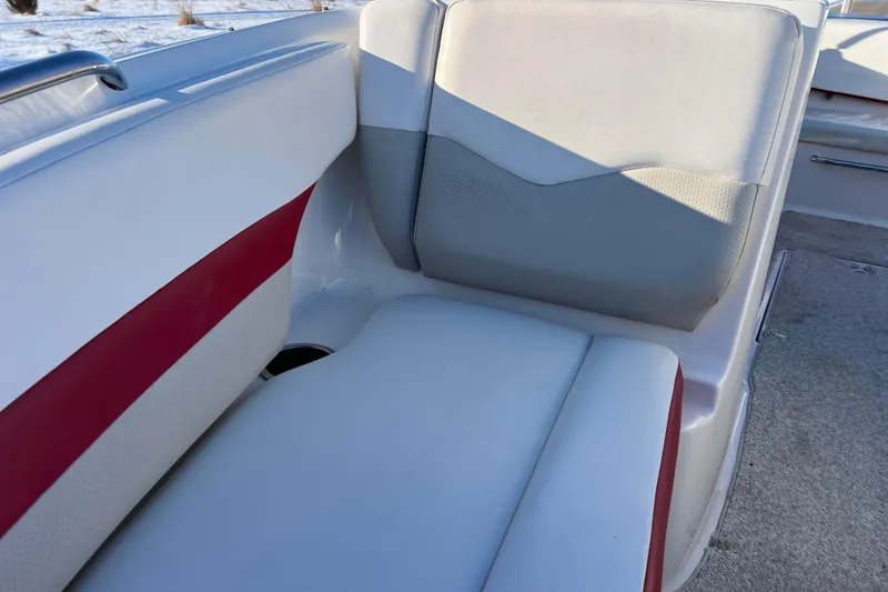 Slide: The Image of 2010 Chaparral 216 SSi boat interior with white and red seating. - 58
