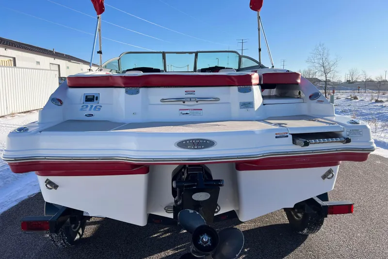 Slide: The Image of 2010 Chaparral 216 SSi boat rear view with red accents and propeller. - 6