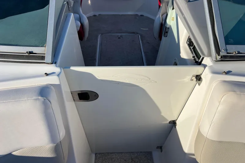 Slide: The Image of 2010 Chaparral 216 SSi boat interior with open door and seating area. - 61