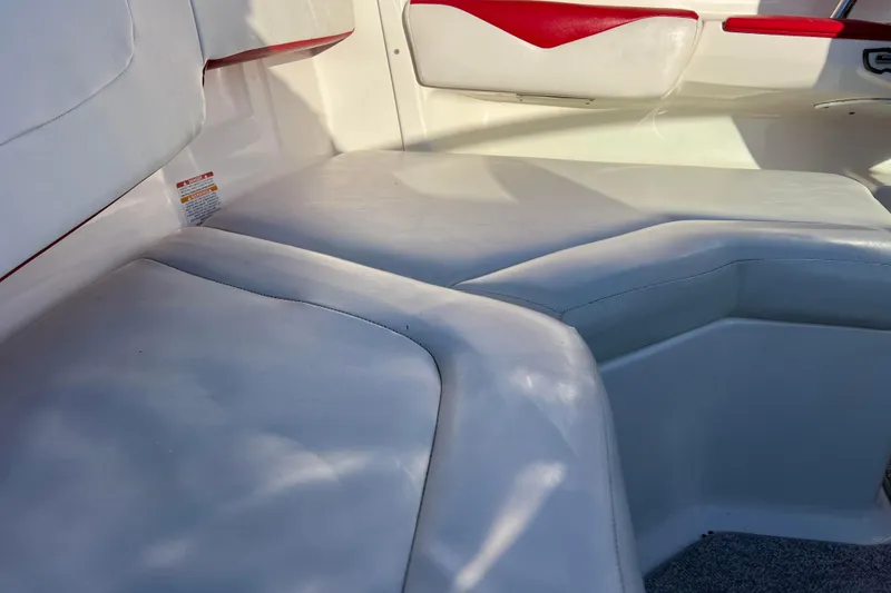 Slide: The Image of 2010 Chaparral 216 SSi boat interior with white and red seating. - 62