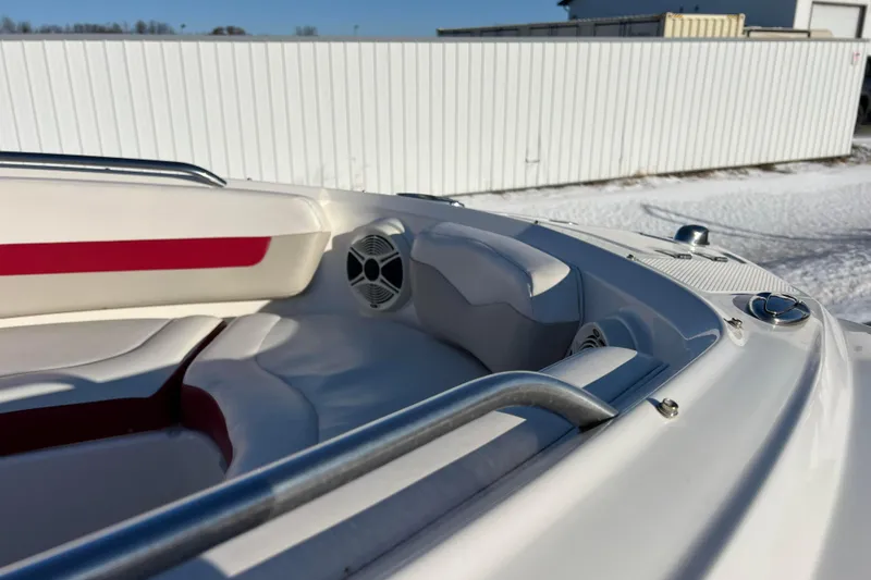 Slide: The Image of 2010 Chaparral 216 SSi boat interior with white and red seating, speaker, and railing. - 68