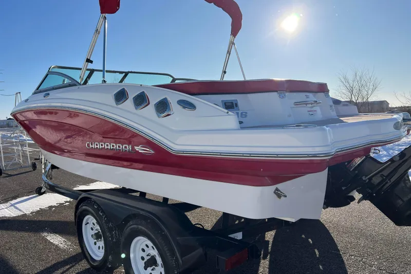 Slide: The Image of 2010 Chaparral 216 SSi boat on trailer, red and white design, sunny day. - 7