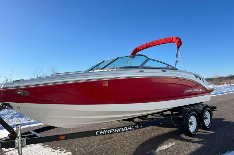Slide: The Image of 2010 Chaparral 216 SSi boat on trailer, red and white design, clear blue sky. - 8