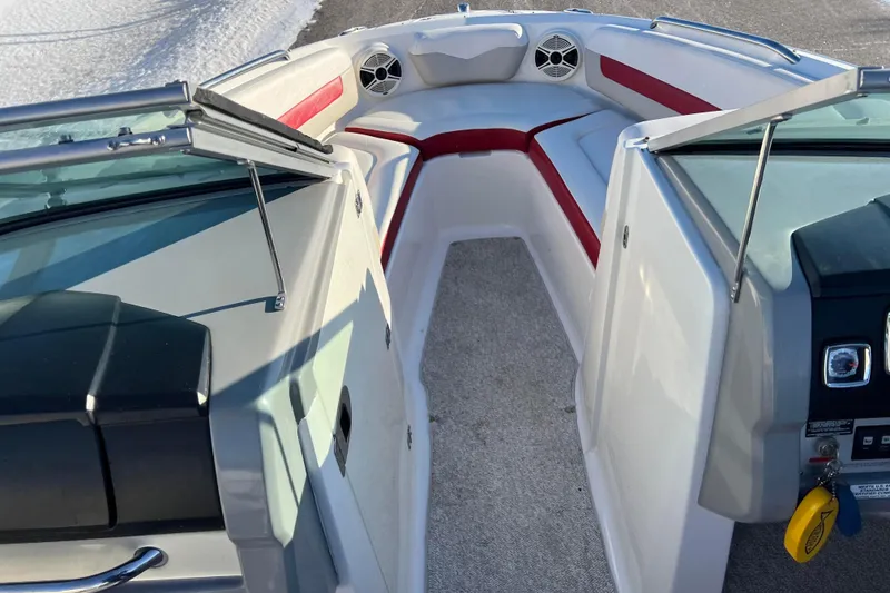 Slide: The Image of 2010 Chaparral 216 SSi boat interior with red and white seating, speakers, and controls. - 84