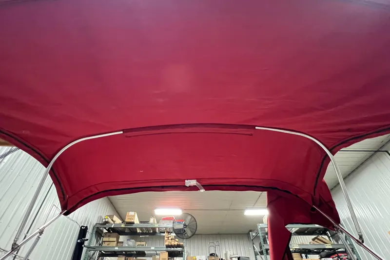 Slide: The Image of Red canopy of a 2010 Chaparral 216 SSi boat in a storage facility. - 89