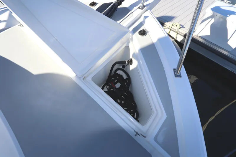 Slide: The Image of Open storage compartment on 2005 Monk 36 boat deck with coiled rope inside. - 16