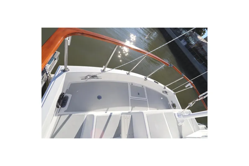 Slide: The Image of 2005 Monk 36 boat deck with polished railing and water reflection. - 19