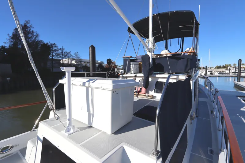 Slide: The Image of 2005 Monk 36 yacht docked at marina under clear blue sky. - 20