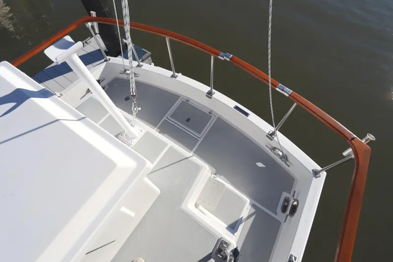 Slide: The Image of 2005 Monk 36 boat deck with wooden railings and storage compartments. - 22