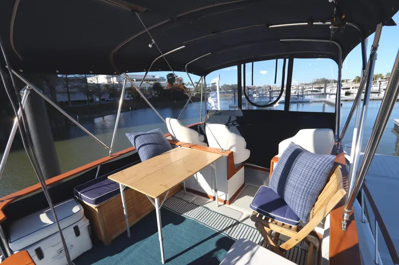 Slide: The Image of Spacious 2005 Monk 36 yacht interior with seating, table, and marina view. - 26
