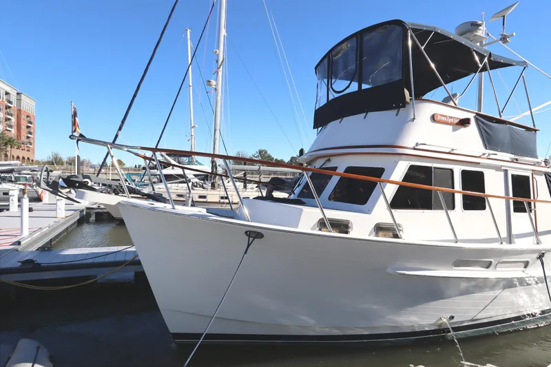 Slide: The Image of 2005 Monk 36 yacht docked at marina under clear blue sky. - 3