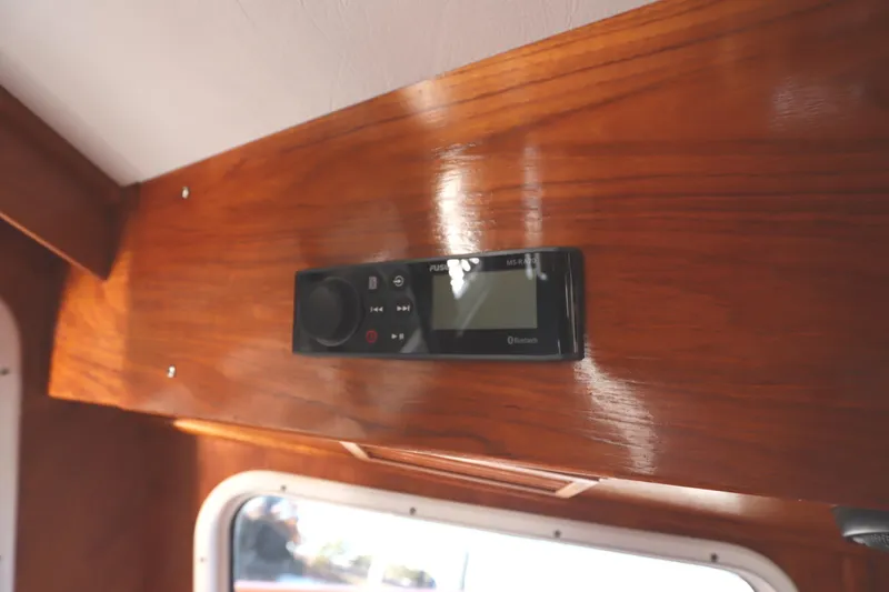 Slide: The Image of Wooden interior of a 2005 Monk 36 boat with a mounted audio system. - 39