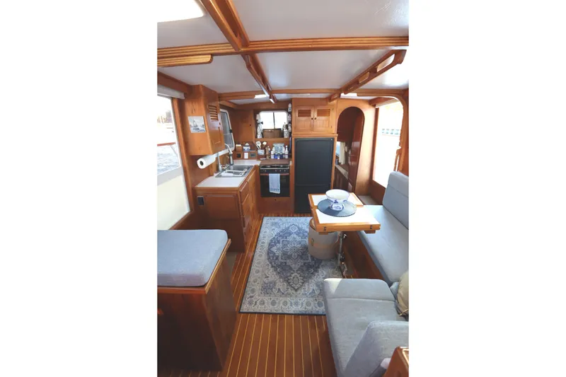 Slide: The Image of Interior of 2005 Monk 36 boat with cozy seating and kitchen area. - 47