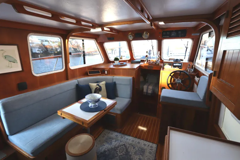 Slide: The Image of Cozy interior of a 2005 Monk 36 boat with wooden accents and blue seating. - 50