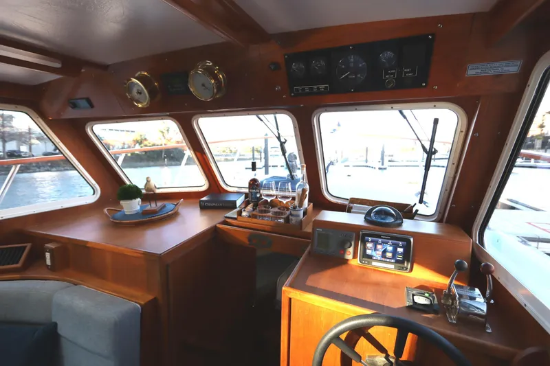 Slide: The Image of Pilothouse interior of 2005 Monk 36 boat with wooden dashboard and navigation equipment. - 51