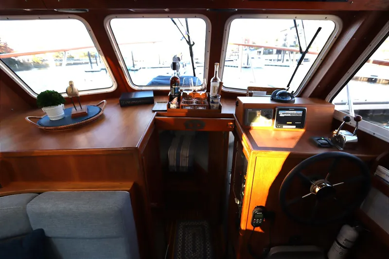 Slide: The Image of Interior of a 2005 Monk 36 boat with wooden helm and navigation equipment. - 52
