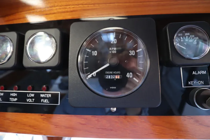 Slide: The Image of Dashboard of a 2005 Monk 36 boat showing RPM and engine hours. - 53