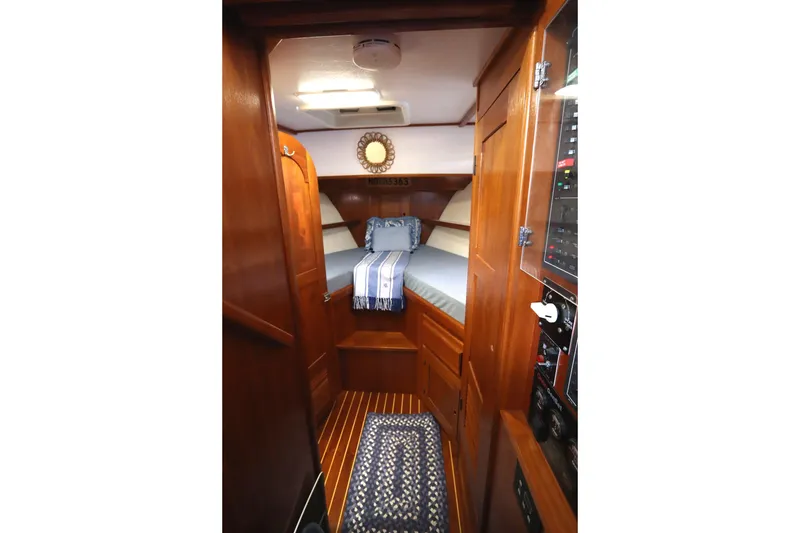 Slide: The Image of Cozy cabin interior of 2005 Monk 36 boat with wooden finish and striped bedding. - 55