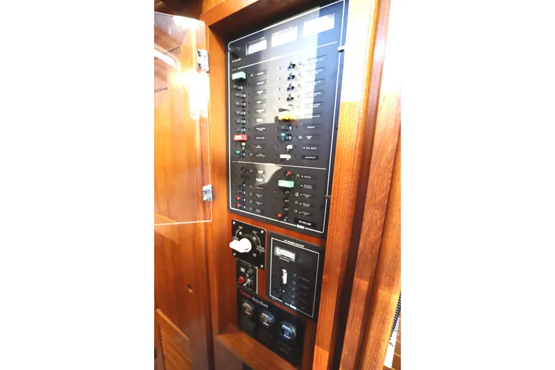 Slide: The Image of Electrical control panel on a 2005 Monk 36 boat, featuring switches and indicators. - 56