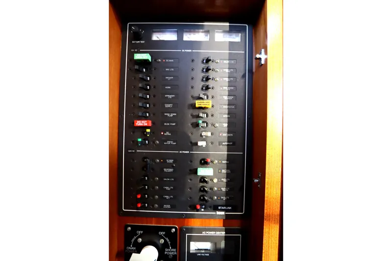 Slide: The Image of Electrical control panel in a 2005 Monk 36 boat, featuring various switches and indicators. - 57