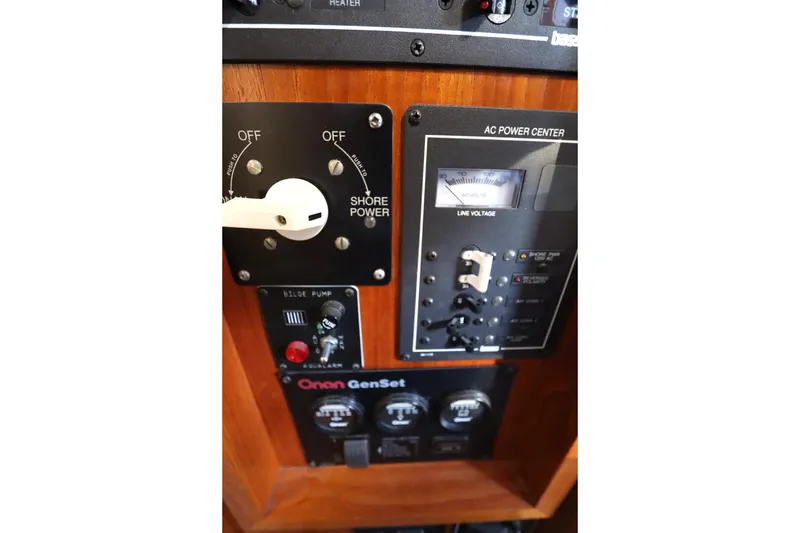 Slide: The Image of Control panel of a 2005 Monk 36 boat, featuring power switches and voltage meter. - 58