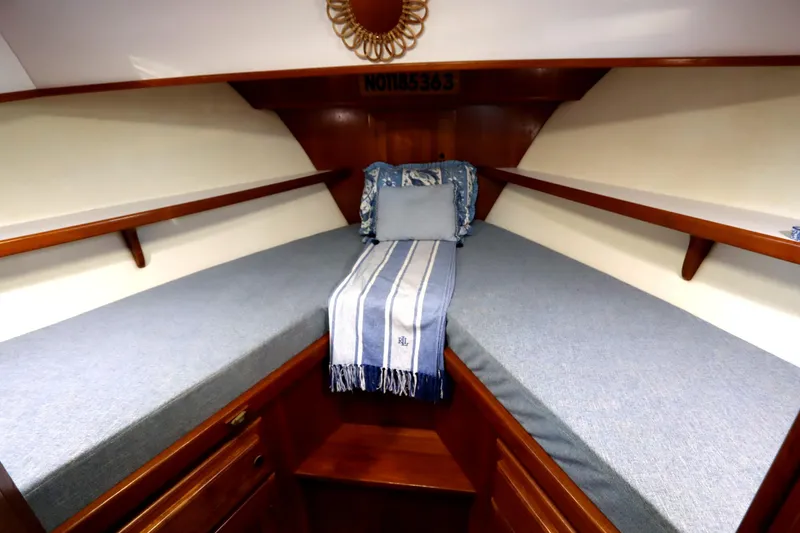 Slide: The Image of Cozy cabin interior of 2005 Monk 36 boat with blue bedding and wooden accents. - 60