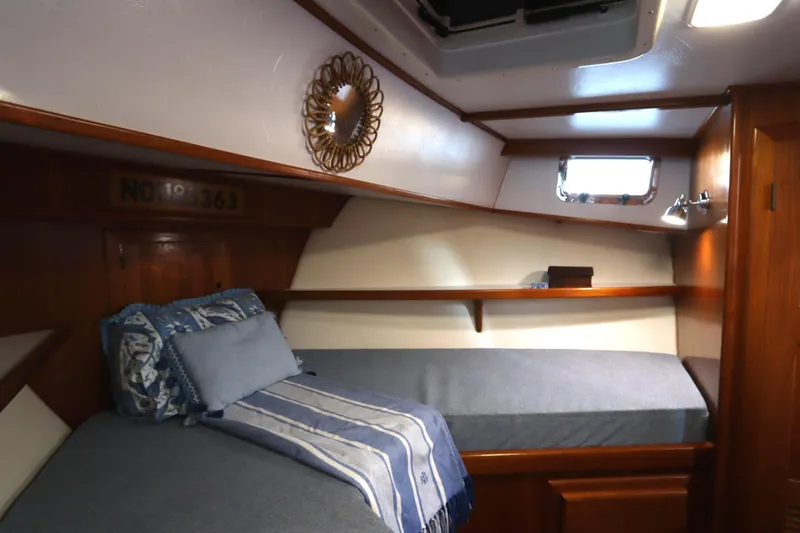 Slide: The Image of Cozy cabin interior of 2005 Monk 36 boat with wooden accents and bedding. - 61