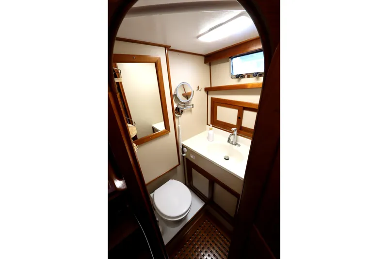 Slide: The Image of Compact bathroom in 2005 Monk 36 boat with wooden accents and modern fixtures. - 63