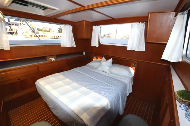 Slide: The Image of Cozy cabin interior of 2005 Monk 36 boat with wooden finish and comfortable bedding. - 70