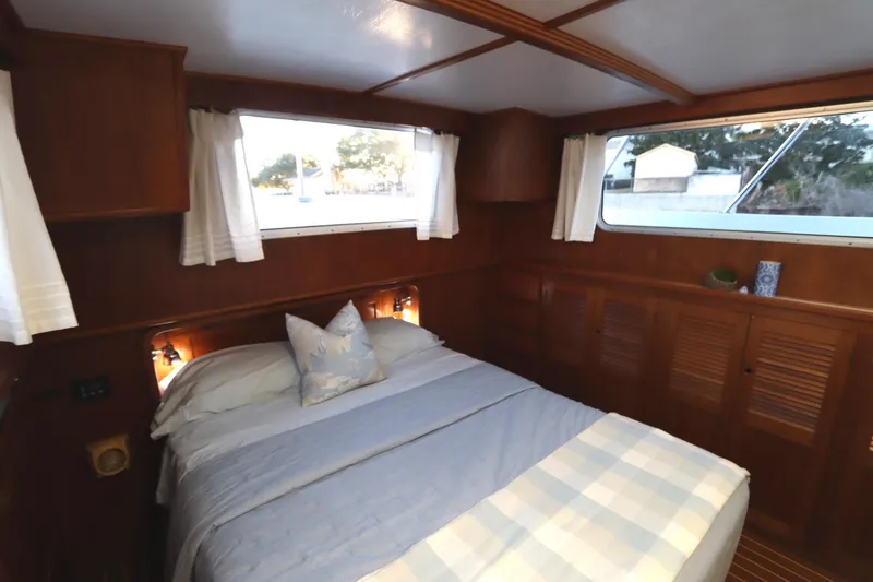 Slide: The Image of Cozy cabin bedroom in 2005 Monk 36 boat with wooden interior and large windows. - 71