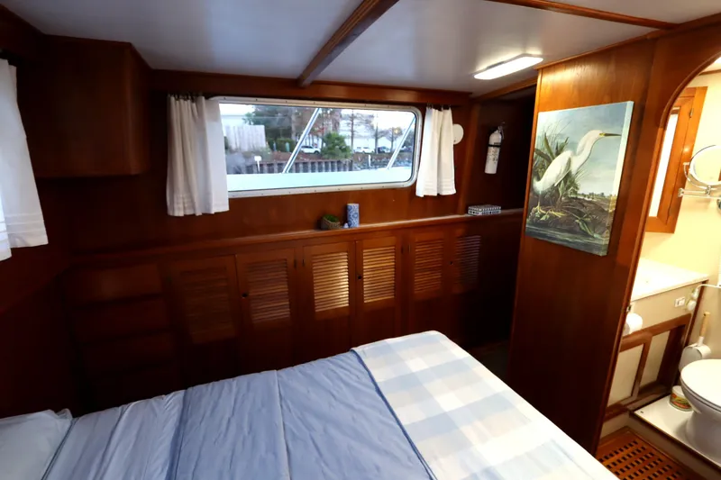 Slide: The Image of Cozy cabin interior of 2005 Monk 36 boat with wooden furnishings and window view. - 74