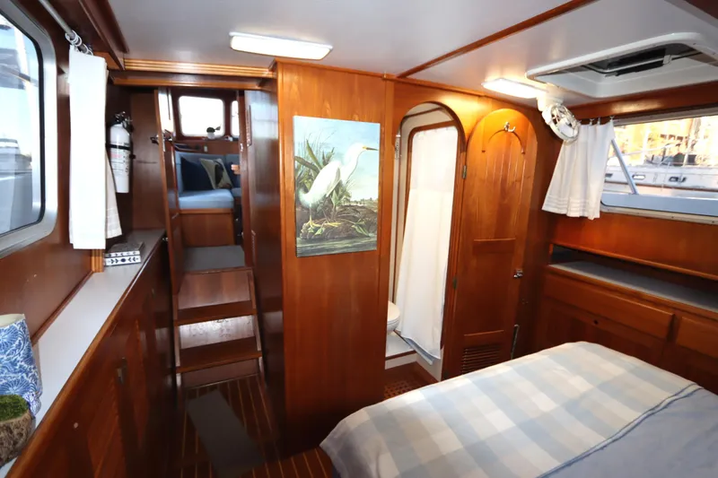 Slide: The Image of Cozy 2005 Monk 36 boat interior with wood paneling, bed, and nautical decor. - 75