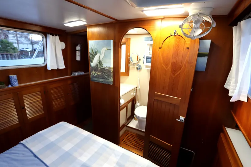 Slide: The Image of Cozy 2005 Monk 36 boat interior with wooden decor and compact bathroom. - 76