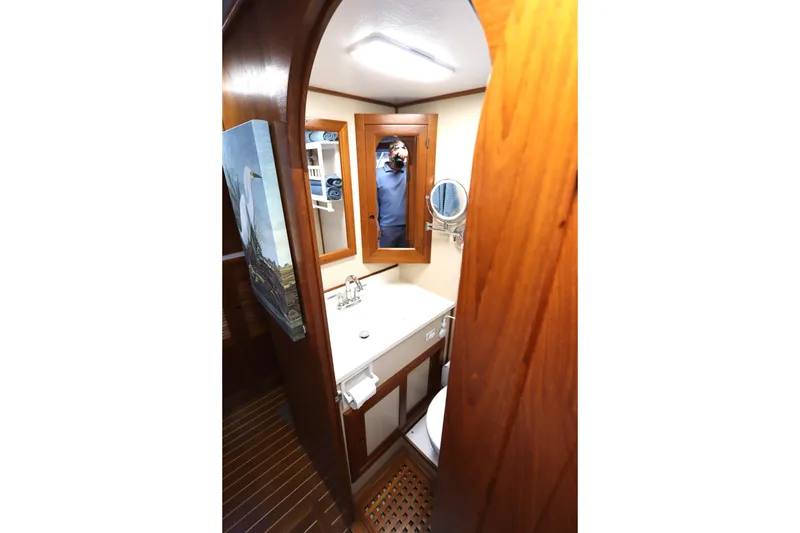 Slide: The Image of Compact bathroom in 2005 Monk 36 boat with wooden accents and mirror. - 77
