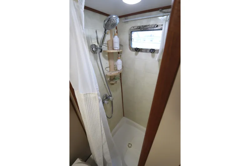Slide: The Image of Compact shower area in 2005 Monk 36 boat with window and showerhead. - 79