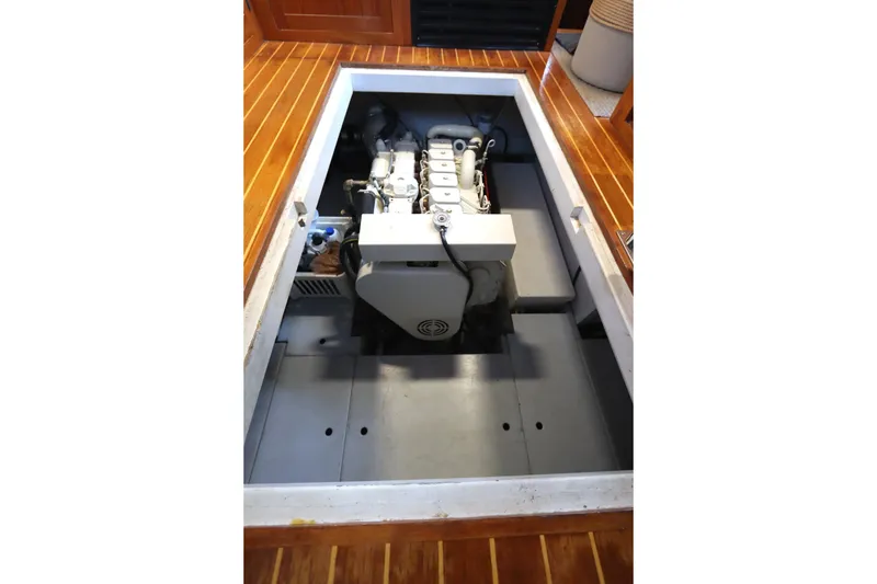 Slide: The Image of Engine compartment of a 2005 Monk 36 boat, showcasing a clean, organized layout. - 80