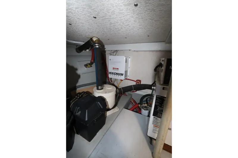 Slide: The Image of Electrical system inside a 2005 Monk 36 boat, featuring Magnum inverter and wiring. - 85