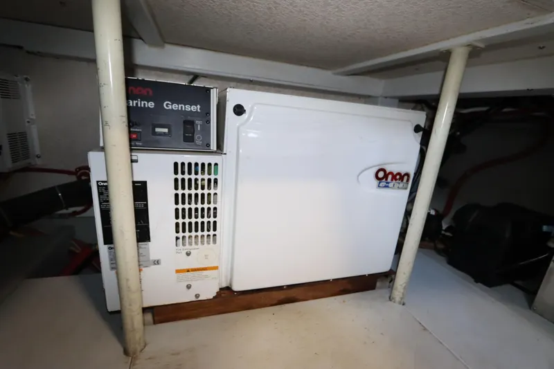 Slide: The Image of Onan marine generator inside a 2005 Monk 36 boat engine room. - 86
