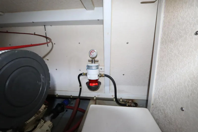 Slide: The Image of Engine compartment of a 2005 Monk 36 boat, featuring a fuel filter and gauge. - 88