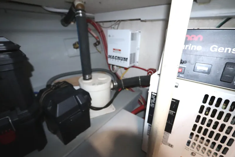 Slide: The Image of Engine room of a 2005 Monk 36 boat, featuring marine generator and equipment. - 89