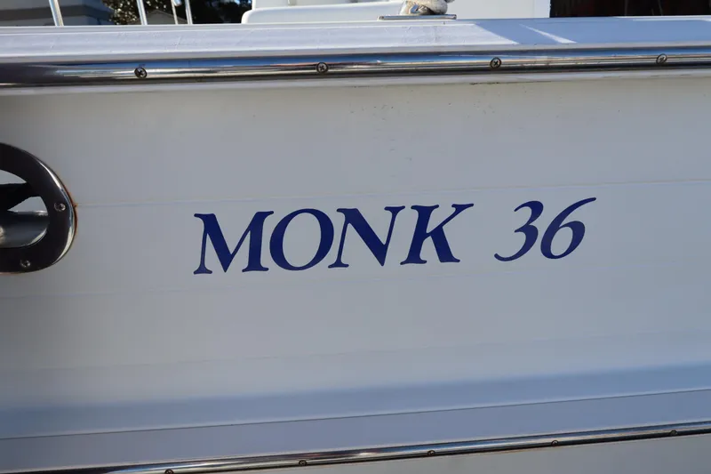 Slide: The Image of Side view of a 2005 Monk 36 boat with blue lettering. - 92