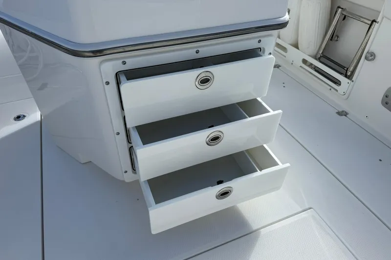 Slide: The Image of Open storage drawers on a 2021 Edgewater 262CC boat, showcasing sleek design and functionality. - 11