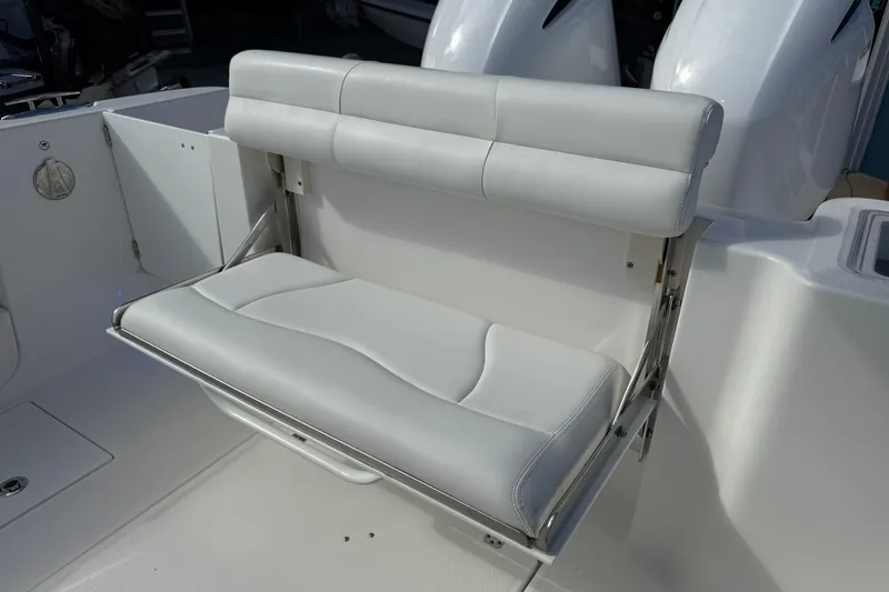 Slide: The Image of White cushioned seat on 2021 Edgewater 262CC boat, featuring sleek design and comfort. - 13