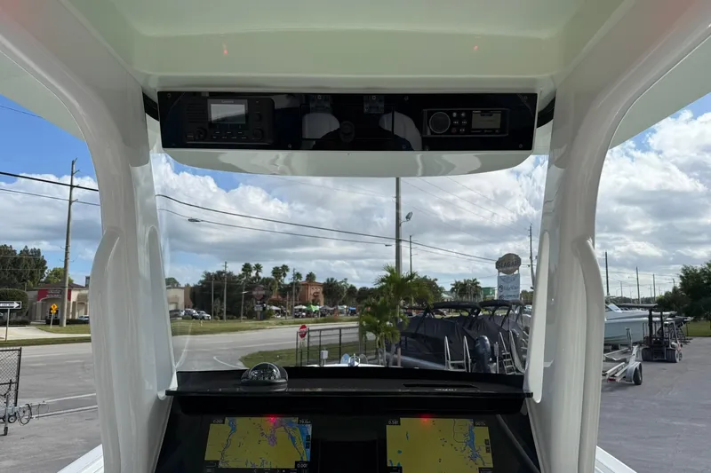 Slide: The Image of Interior view of 2021 Edgewater 262CC boat with navigation equipment and clear windshield. - 18