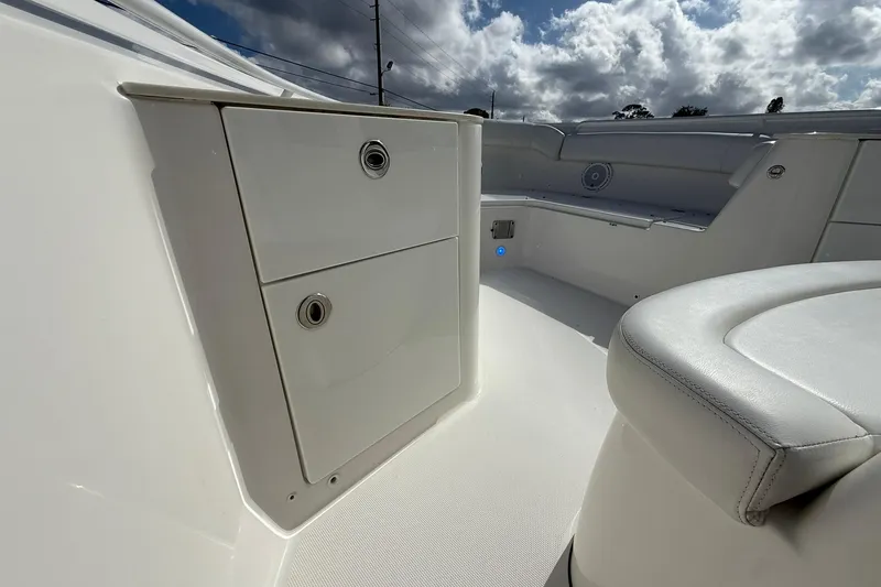 Slide: The Image of 2021 Edgewater 262CC boat interior with storage compartments and seating. - 23
